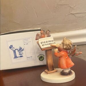 Goebel Bird Duet Figurine. Angel with Orange Coat and Music Stand and birds